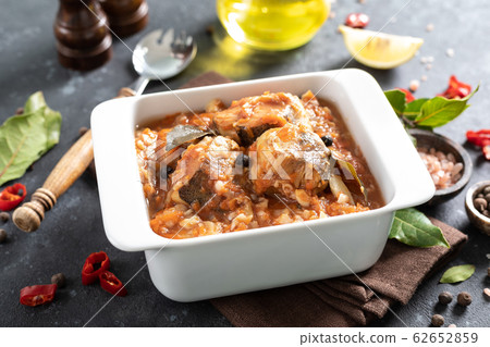 Hake fish, cooked in tomato sauce with vegetables 62652859
