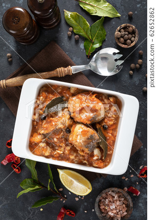 Hake fish, cooked in tomato sauce with vegetables Hake fish, cooked in tomato sauce with vegetables 62652862