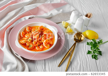 Prawn scampi with garlic and butter on a plate 62653345