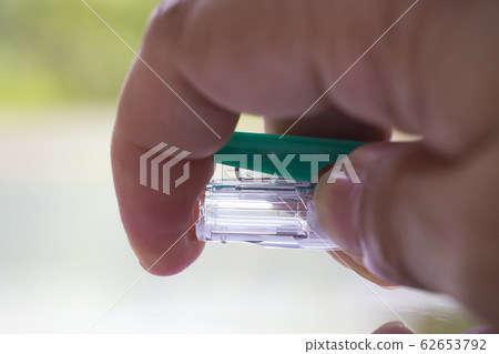 Woman's right Hand press gel ink pen or plastic ballpoint pen on white acrylic background, Close up & Macro shot, Select focus, Communication, Business, Education, Stationery concept Woman's right Hand press gel ink pen or plastic ballpoint pen on white acrylic background, Close up & Macro shot, Select focus, Communication, Business, Education, Stationery concept 62653792