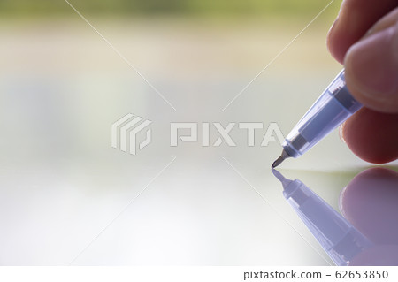 Woman's right Hand holding transparent plastic ballpoint pen, Writing letter on white acrylic background, Close up & Macro shot, Selective focus, Communication, Business, Education, Stationery conce Woman's right Hand holding transparent plastic ballpoint pen, Writing letter on white acrylic background, Close up & Macro shot, Selective focus, Communication, Business, Education, Stationery conce 62653850