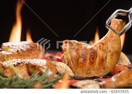 Grilled chicken thigh with various vegetables on  chopping wood 62653935