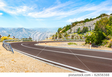 Turn of road in mountains 62656388