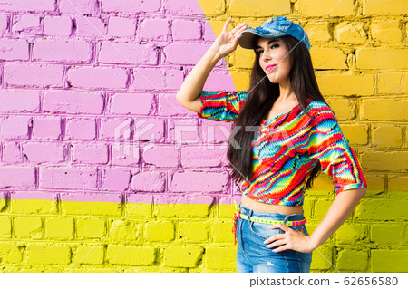 Street dance, freestyle and jazz funk concept - Beautiful girl hip-hop dancer over brick wall with copy space. 62656580