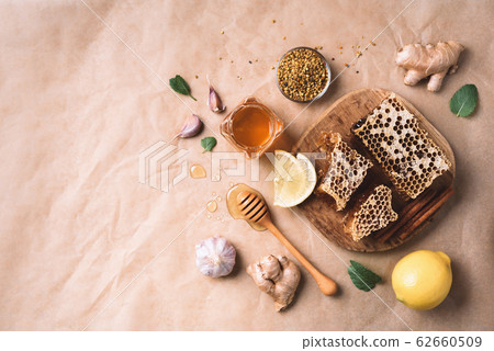 Ingredients for healthy hot drink. Lemon, ginger, mint, honey, apple and spices on craft paper background. Copy space. Top view. Alternative medicine concept. Clean eating, detox 62660509