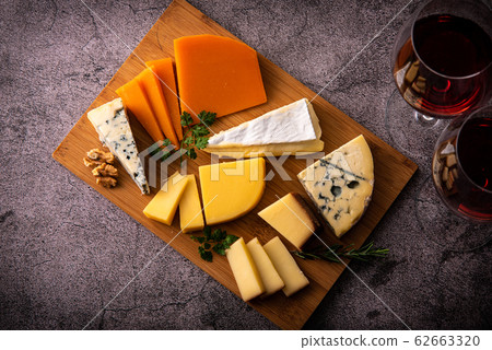 Assorted cheeses of various types and red wine 62663320