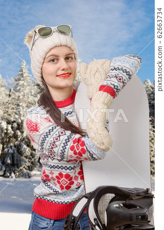 portrait of a happy young girl snowboarding with 62663734