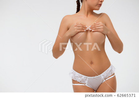 Crop sensual woman covering breast 62665371