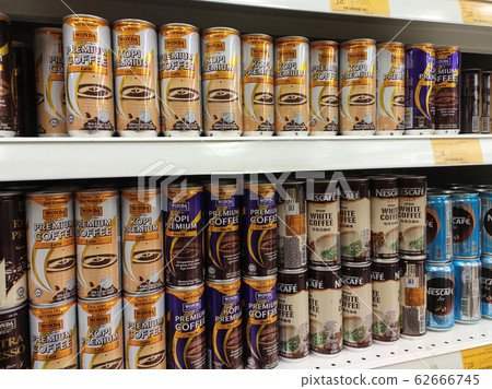 Coffee drinks in many flavours in aluminium cans. It comes in many brands. Some are mixed with cream as a seasoning. On display for sale on supermarket shelves. 62666745