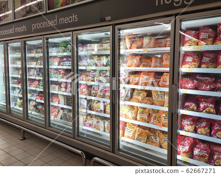 Frozen foods displayed on the rack inside the large chiller in the supermarket. Displayed and arranged by the brand to make easy for the customer to select.  62667271