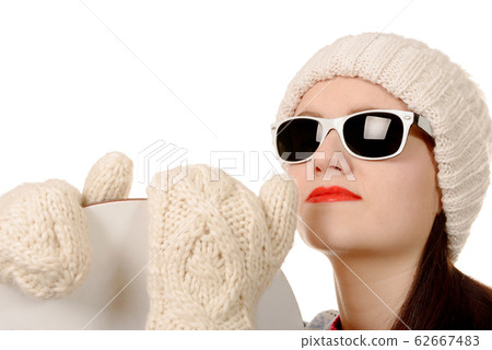 beautiful woman with a snowboard and sunglasses in 62667483