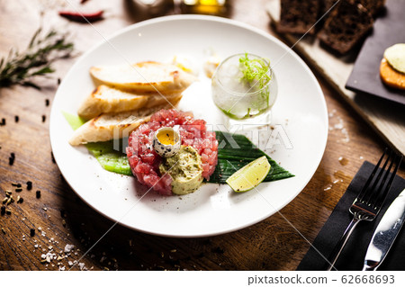 Tuna tartare served on a plate in restaurant 62668693