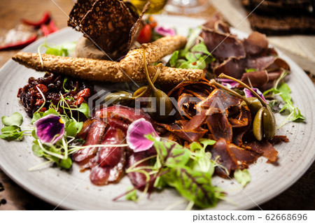 Meat platter for two served on a plate in restaurant 62668696