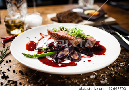 Duck breast served on a plate in restaurant Duck breast served on a plate in restaurant 62668700
