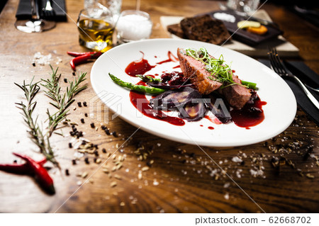 Duck breast served on a plate in restaurant 62668702