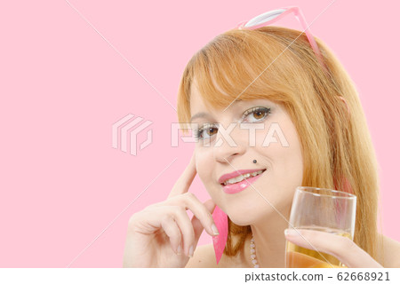 pretty redhead woman drinks a glass of wine, 62668921
