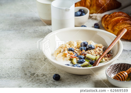 Breakfast muesli with fruits and croissants 62669589
