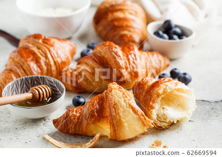 Fresh croissants with blueberries, butter  62669594