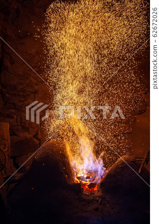 Smithy fire flame tips with sparks closeup 62672026