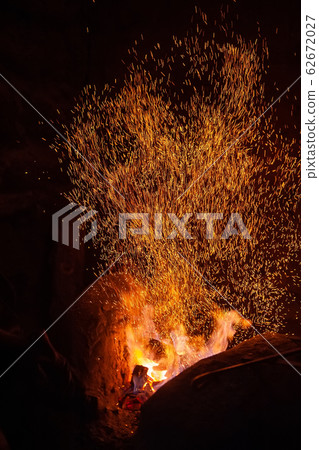 Smithy fire flame tips with sparks closeup 62672027