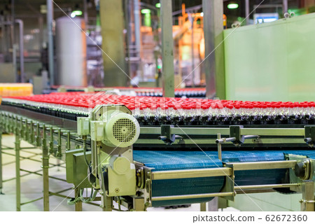 View of plastic bottles at bottling line at soft drinks factory View of plastic bottles at bottling line at soft drinks factory 62672360