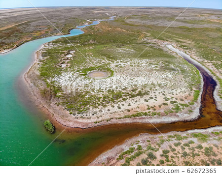 Small red water river and green water lake in Bogdo-Baskunchak Nature Reserve 62672365