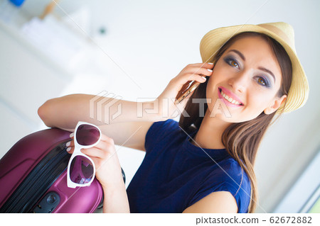 Beautiful girl sitting on the bed and goes on vacation 62672882