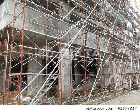 Temporary access and metal staircase made from staging and scaffolding the construction site. Designed by licence scaffolder to make sure it is safe to use. Temporary access and metal staircase made from staging and scaffolding the construction site. Designed by licence scaffolder to make sure it is safe to use. 62675827