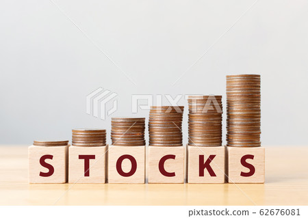 Money coins stack stair as step growing growth and wooden cube block with word STOCKS Money coins stack stair as step growing growth and wooden cube block with word STOCKS 62676081
