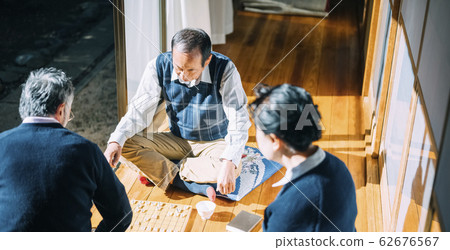Senior man playing shogi Senior man playing shogi 62676567