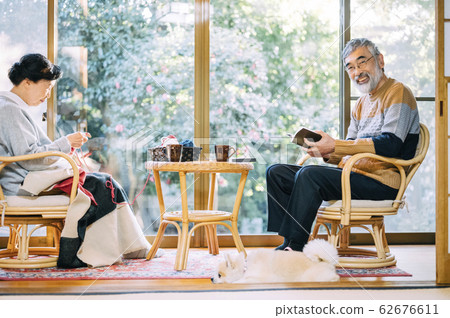Senior couple relaxing with a dog Senior couple relaxing with a dog 62676611