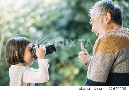 Grandpa and grandson using camera 62676668
