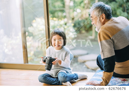 Grandpa and grandson using camera 62676676