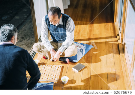 Senior man playing shogi 62676679