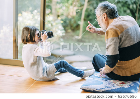 Grandpa and grandson using camera 62676686