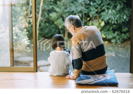 Grandpa and grandson using camera 62676816