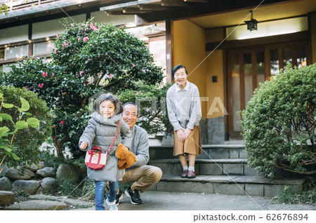 Senior, husband and wife, grandchild 62676894