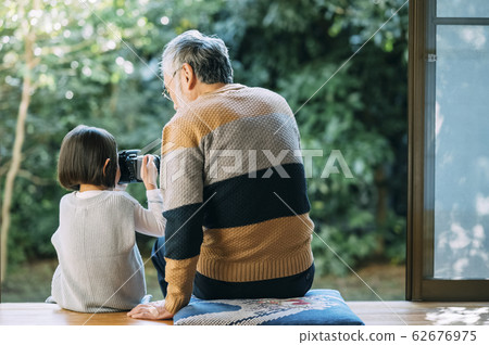 Grandpa and grandson using camera 62676975