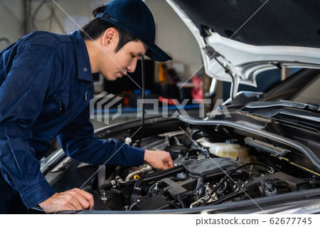 male mechanic checking and repair engine, car male mechanic checking and repair engine, car 62677745