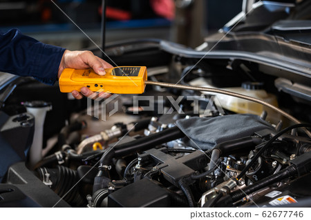 mechanic hand check for leaks in GAS LPG gasoline 62677746