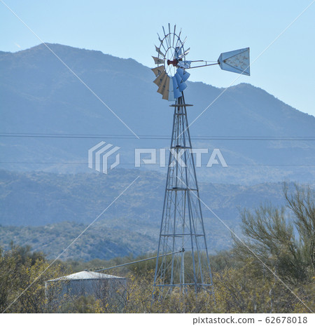 Windmill pumping water to the water tank in Mohave County, Sonoran Desert, Arizona USA Windmill pumping water to the water tank in Mohave County, Sonoran Desert, Arizona USA 62678018