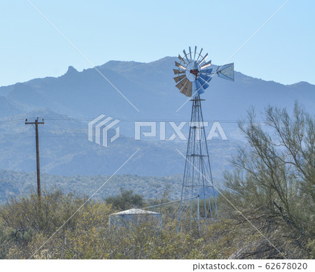 Windmill pumping water to the water tank in Mohave County, Sonoran Desert, Arizona USA Windmill pumping water to the water tank in Mohave County, Sonoran Desert, Arizona USA 62678020