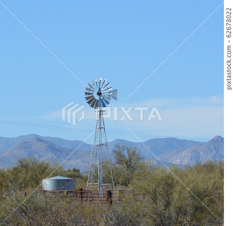 Windmill pumping water to the water tank in Mohave County, Sonoran Desert, Arizona USA Windmill pumping water to the water tank in Mohave County, Sonoran Desert, Arizona USA 62678022