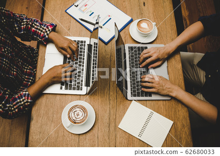 two businessmen working together by using laptop; business work concept 62680033