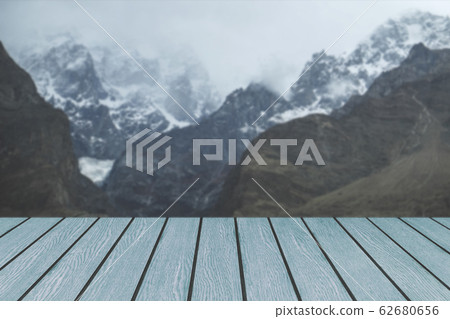 Wooden planks against snow capped mountain range Wooden planks against snow capped mountain range 62680656