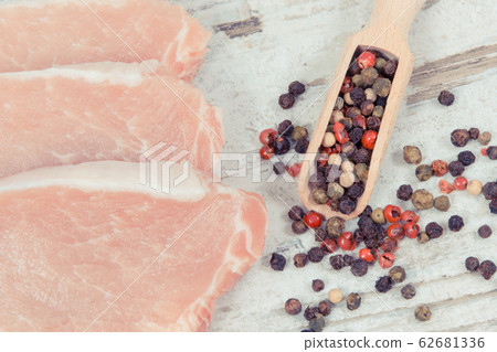 Slices of fresh loin with pepper on spoon Slices of fresh loin with pepper on spoon 62681336