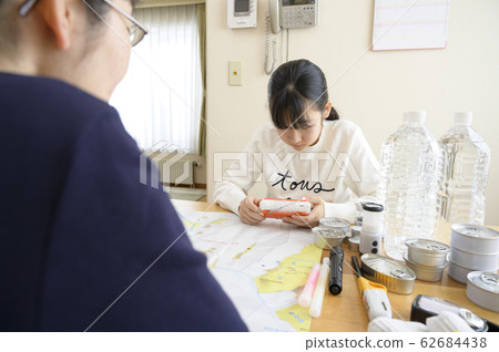 Family (radio) checking emergency supplies 62684438