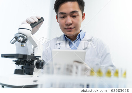 Positive delighted young researcher reading good news Positive delighted young researcher reading good news 62685638