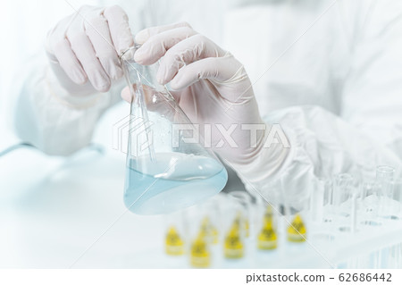 Competent scientist doing chemical experiment in lab Competent scientist doing chemical experiment in lab 62686442