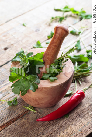 Red pepper and various herbs on a old wooden Red pepper and various herbs on a old wooden 62687010